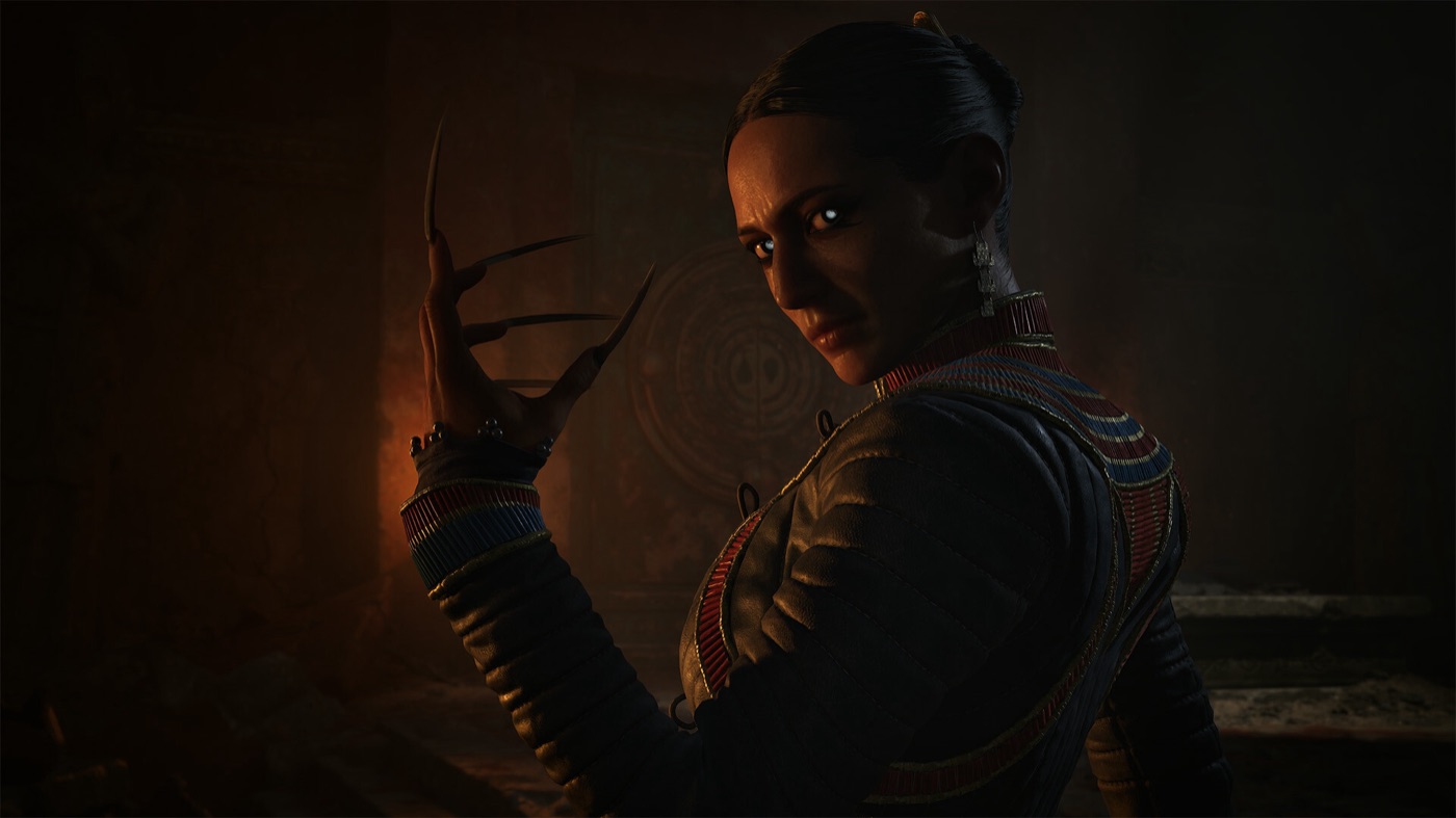 A cloaked character stands in a dark torch-lit interior